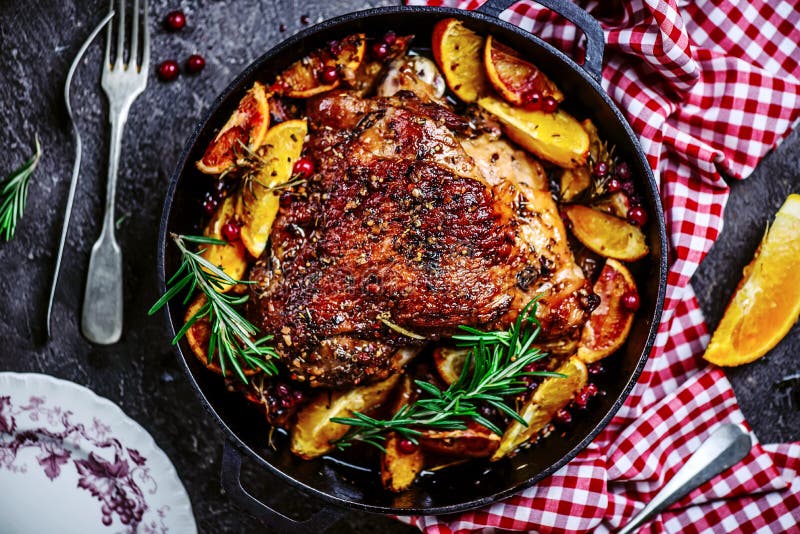 Turkey thigh baked with oranges and cranberries...style rustic.selective focus. Turkey thigh baked with oranges and cranberries...style rustic.selective focus