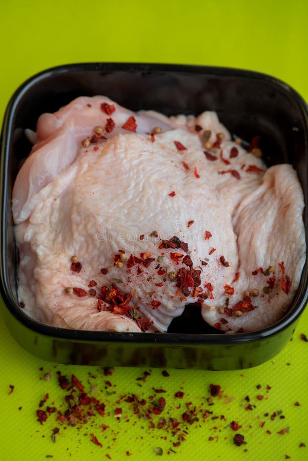 Fresh skinless chicken thighs. Raw chicken thigh. Raw chicken thigh on dark green background. Fresh skinless chicken thighs. Raw chicken thigh. Raw chicken thigh on dark green background