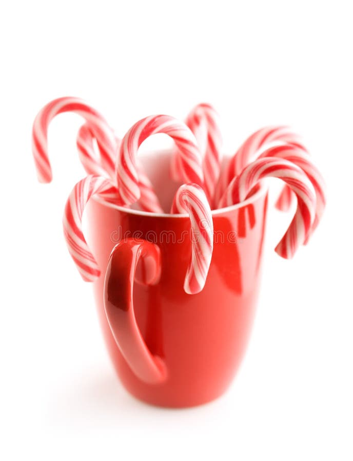 Red and white candy canes in red cup. Red and white candy canes in red cup