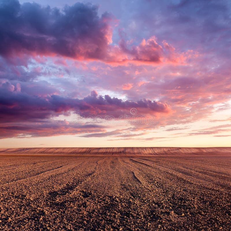 Cultivated land and cloud formations at sunset stock photo Cultivated land and cloud formations at sunset stock photo