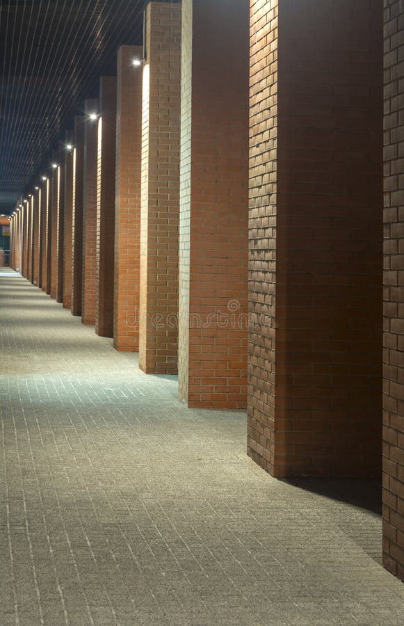 Night view. Industrial building. Office buildings in loft style. Long corridor. Red brick house. Night view. Industrial building. Office buildings in loft style. Long corridor. Red brick house.