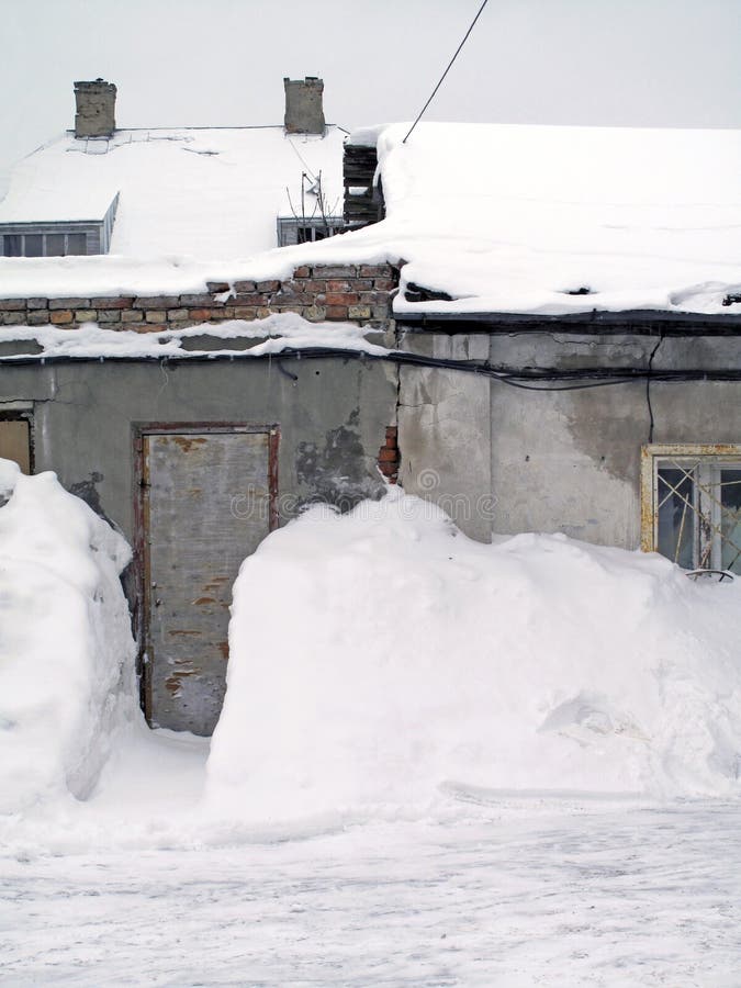 A shoveled snowdrift clearing to the entrance of an old urban home in the backstreets of Riga, Latvia. A shoveled snowdrift clearing to the entrance of an old urban home in the backstreets of Riga, Latvia.