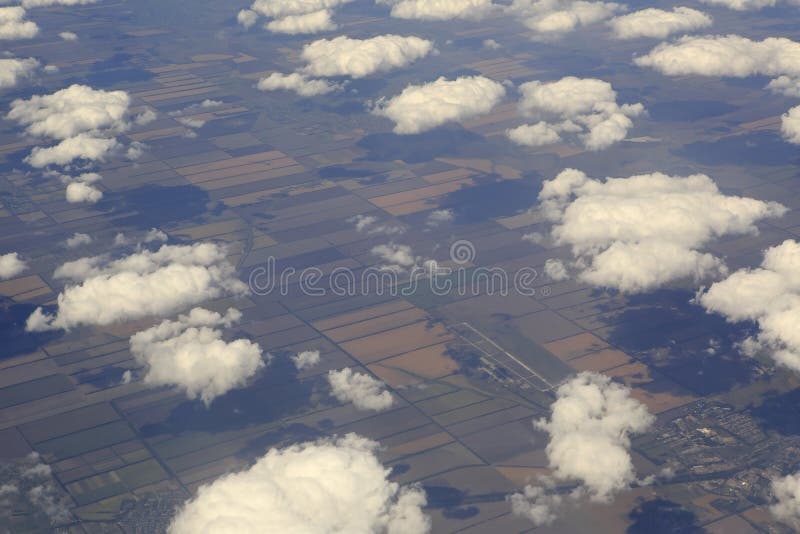 Cumulus clouds over the fields from airplane view