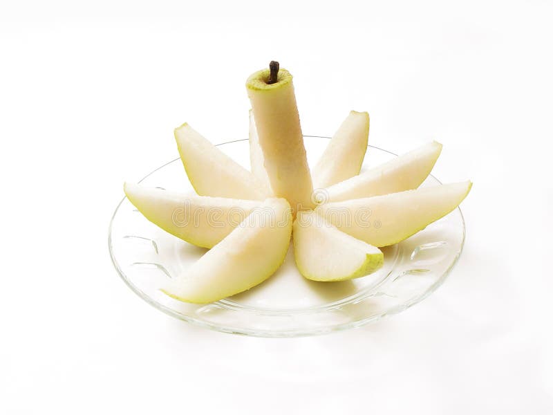 Decoratively sliced pear on a clear plate. Decoratively sliced pear on a clear plate