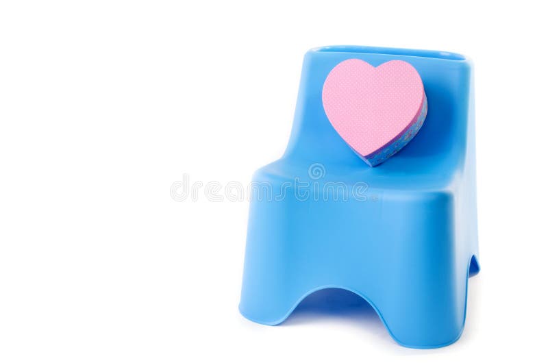 Pink box heart with plastic chair isolated on white background . Pink box heart with plastic chair isolated on white background .