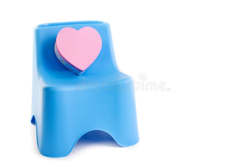 Pink box heart with plastic chair isolated on white background . Pink box heart with plastic chair isolated on white background .