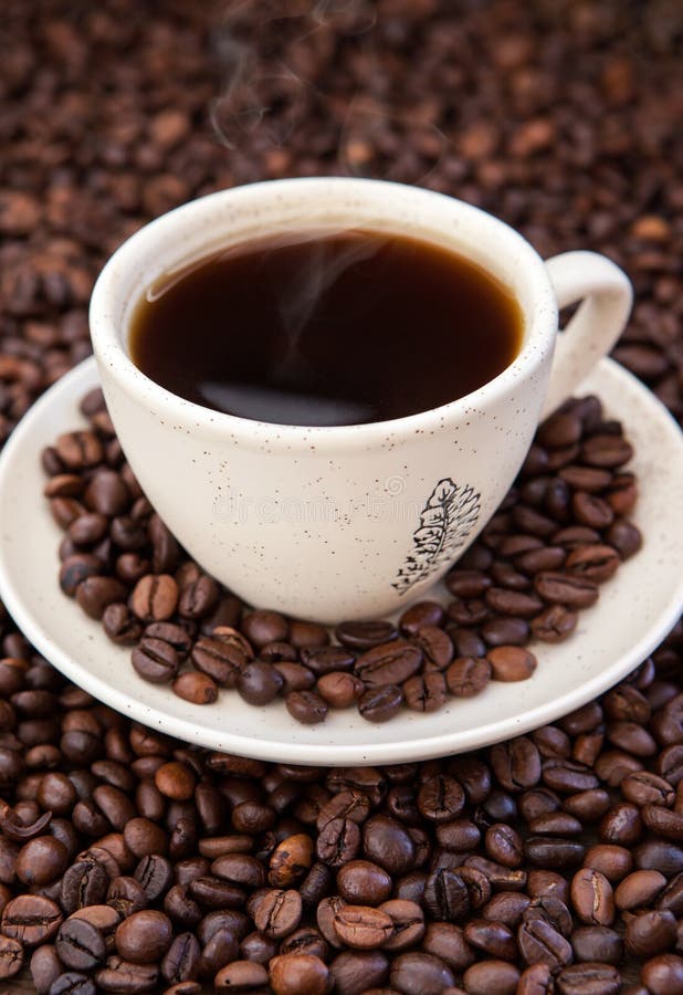 Cup Of Black  Coffee  With Coffee  Beans  Around Stock Image 