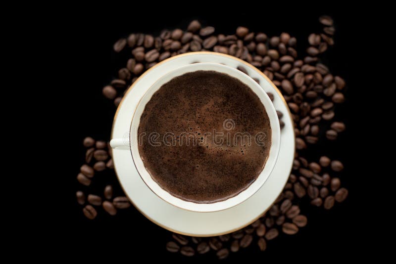 Cup of Black Coffee with Foam on Background of Roasted Coffee Be Stock