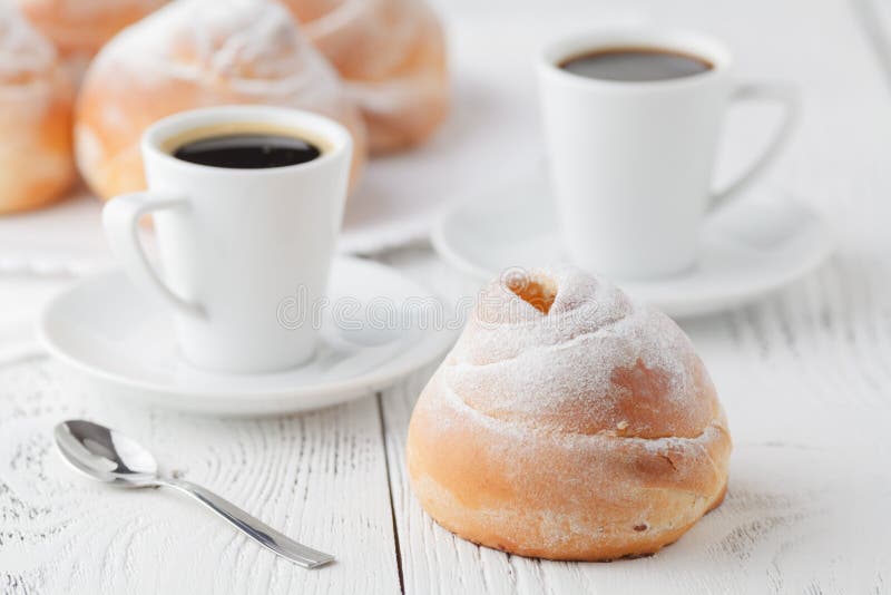 Cup of black coffee and sweet bun for breakfast, close-up. Morning, food.