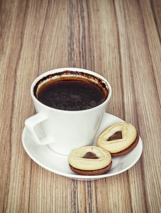 Cup of Black Coffee with Two Jam Biscuits in the Shape of Heart Stock