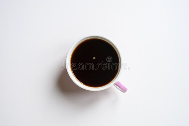 Cup with black or dark brown rich chaga tea brewed from birch tree chaga mushroom isolated on a white background.