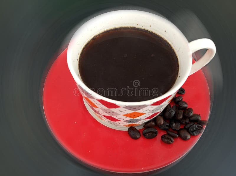 A cup of black morning coffee and raw coffee beans. Top view, high angle view. Fresh morning coffee drink concept. Copy space.