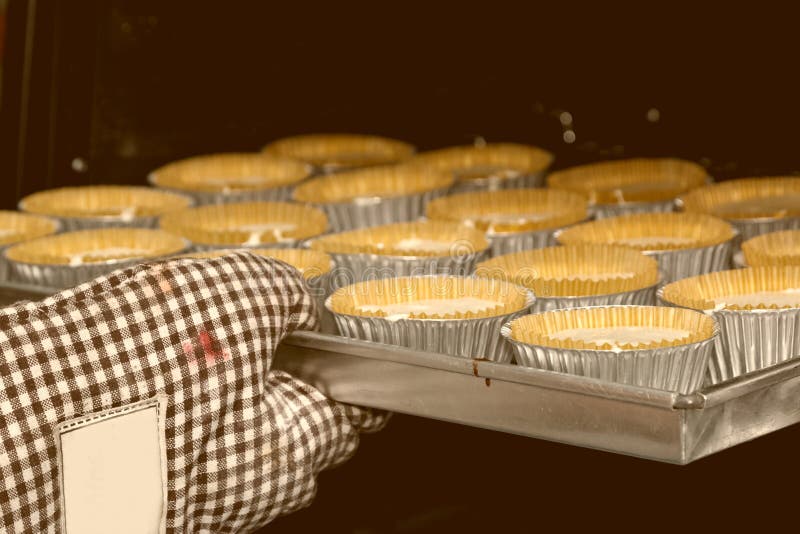 Cup cakes baking in oven.