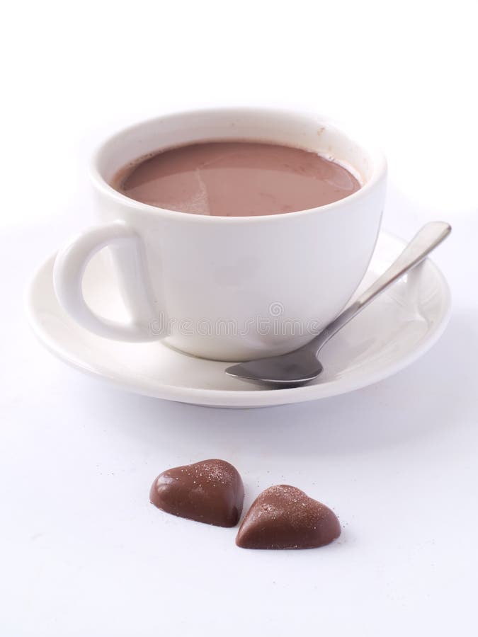 Cup of cappuccino with two chocolate hearts
