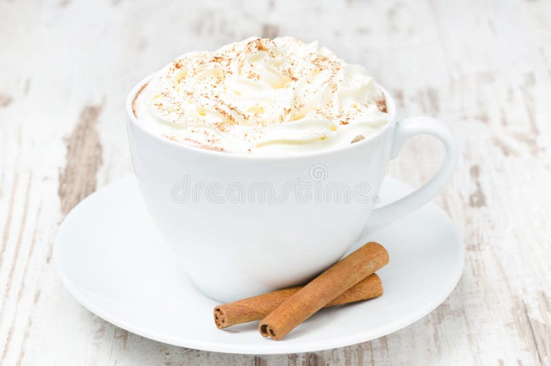 Cup of cocoa with cinnamon and whipped cream