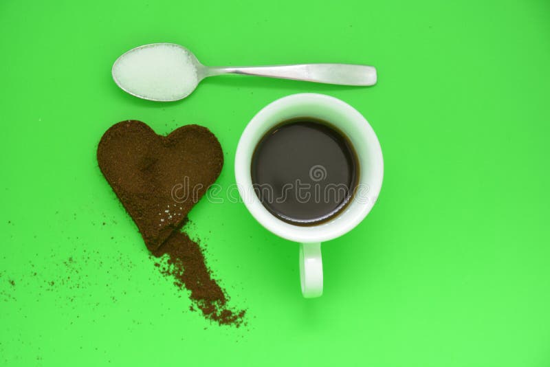 Cup of coffe and white sugar on metal spoon and coffe heart royalty free stock photo Cup of coffe and white sugar on metal spoon and coffe heart royalty free stock photo