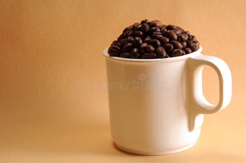 Cup of coffee beans stock image. Image of black, house 37696299