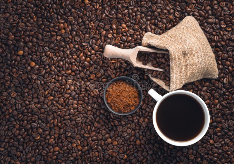 A Cup of Coffee, Coffee Beans in a Bag and Ground Coffee on Coffee