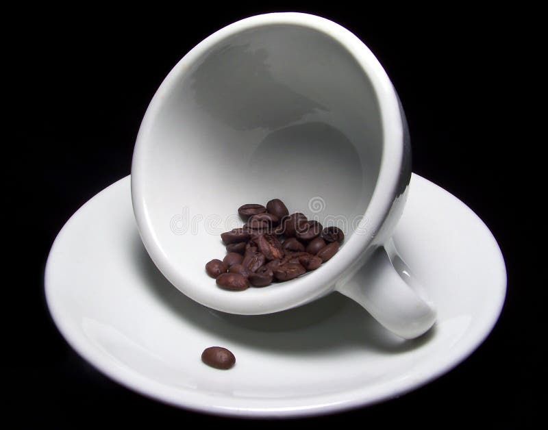 Cup of coffee beans on saucer