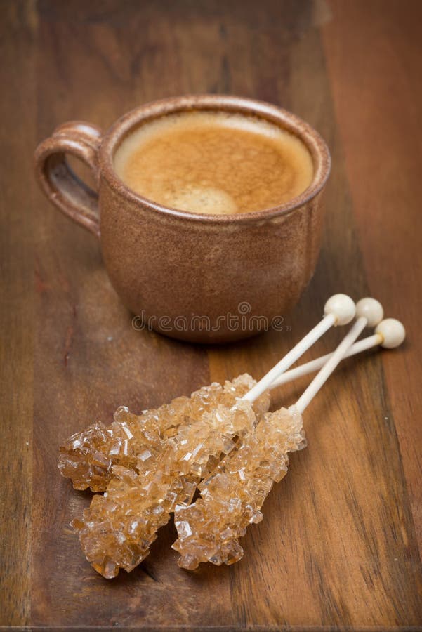 Cup of coffee and caramel sugar on sticks, selective focus