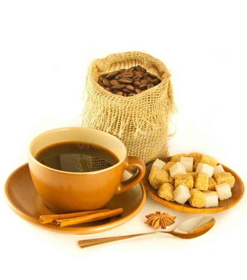 Cup of coffee with chocolates, coffee grains