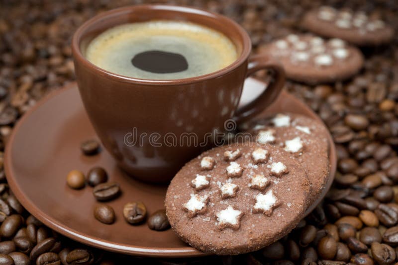 Cup of Coffee and Christmas Cookies on the Coffee Beans Stock Photo