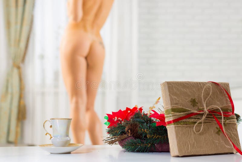 A cup of coffee and a Christmas present on the background of a n