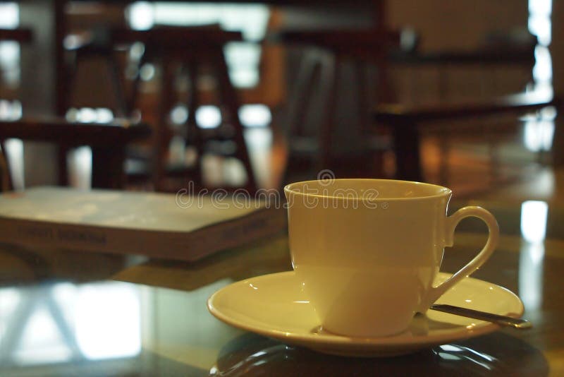 Cup of Coffee in Coffee Shop with Book for Reading Stock Image Image