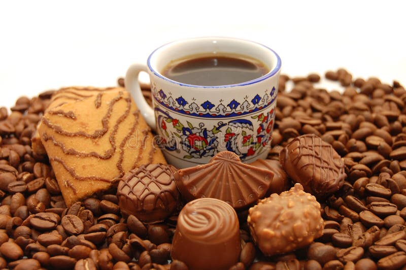 Cup coffee with cookies and chocolates