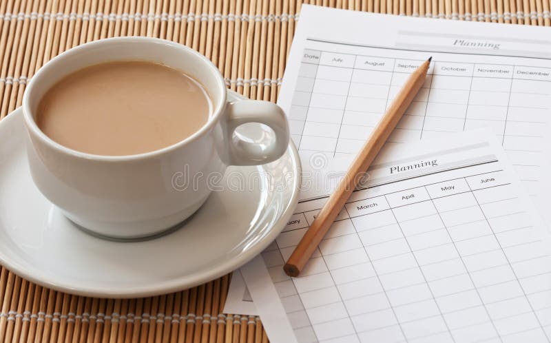 A cup of coffee cup with planning paper