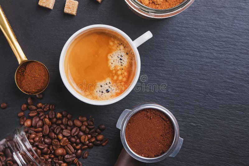 A Cup of Coffee and Filter Holder of Espresso Maker and with Scattered