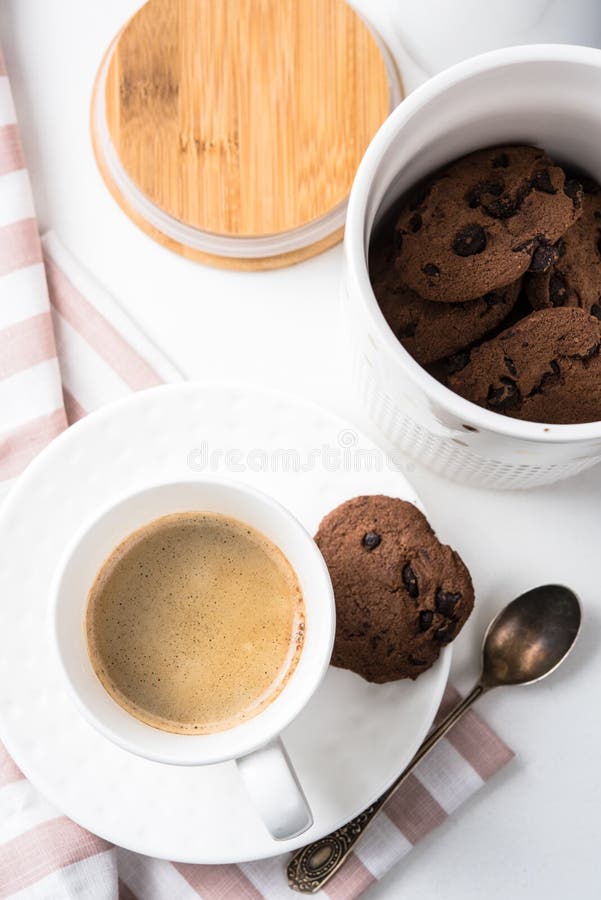 Cup of coffee and jar of chocolate cookies