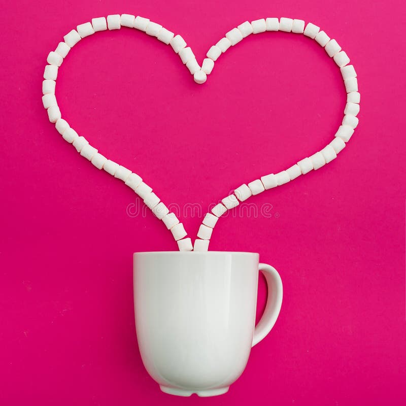 Cup of coffee and marshmallows on pink background. Heart symbol and Love. Flat lay. Top view. Cup of coffee and marshmallows on pink background. Heart symbol and Love. Flat lay. Top view