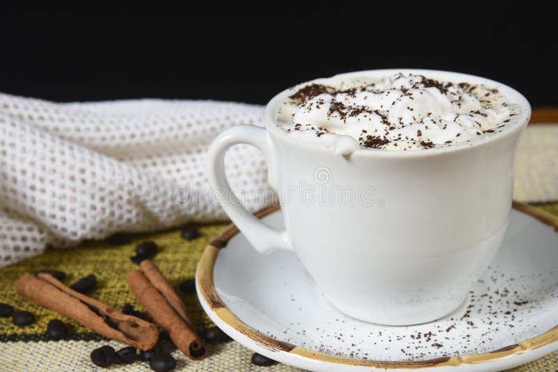 Cup of Coffee with Milk and Whipped Cream on the Table with Roasted