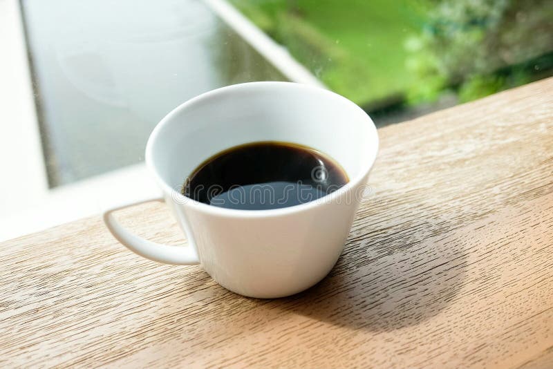 Cup Of Coffee Nearly Window Under Sunrise Light With Garden View Stock