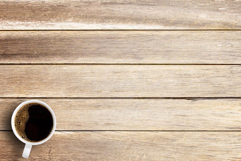 Cup of coffee on a office desk or wood table background.