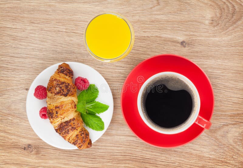 Cup of coffee, orange juice and fresh croissant stock photo Cup of coffee, orange juice and fresh croissant stock photo