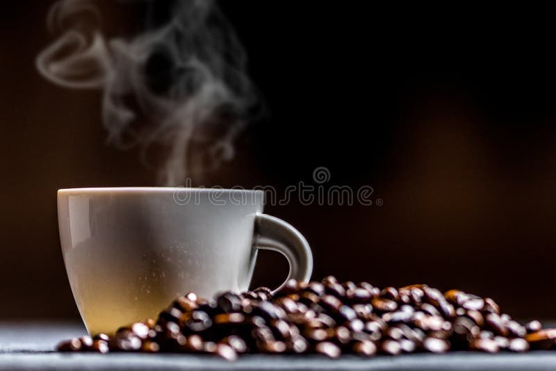 Cup of coffee with smoke stock photo. Image of bean 140543476