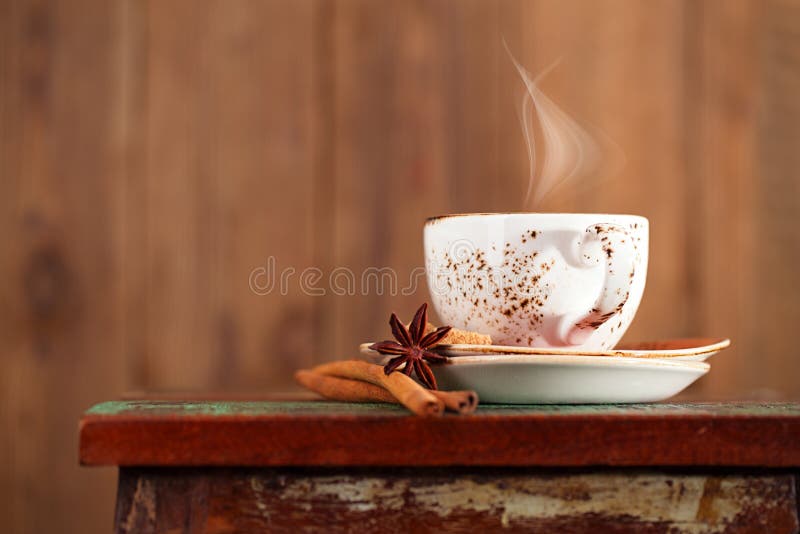 Cup of coffee with steam, cinnamon, anise on a beautiful rustic background. Warm steam stock images, royalty-free photos and pictures