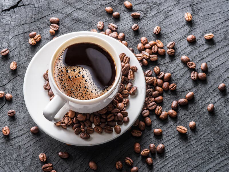 Cup of coffee surrounded by coffee beans. Top view. royalty free stock photography