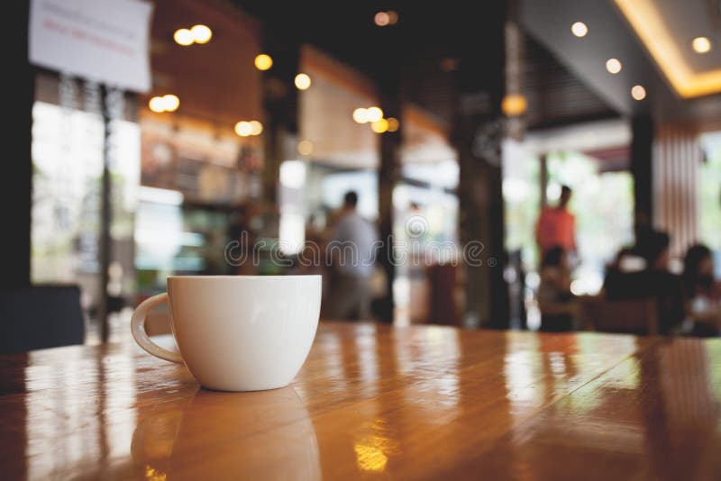 Cup of coffee on table in cafe. Vintage tone royalty free stock image