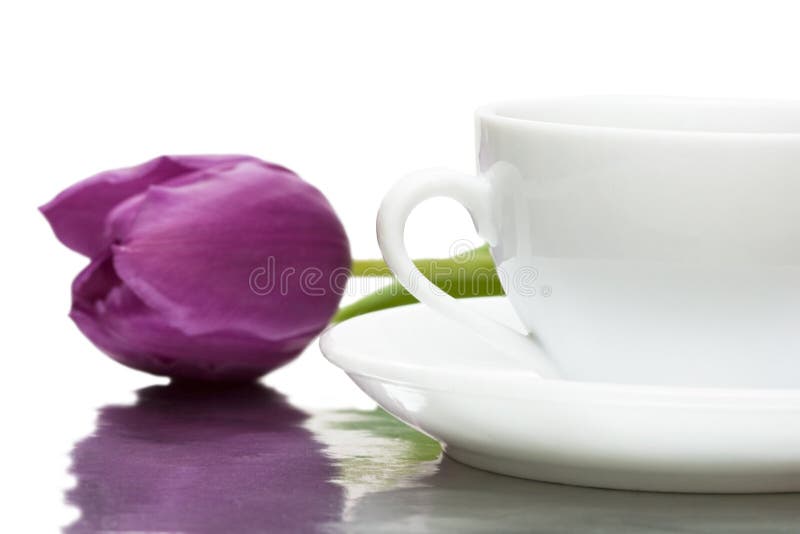 Cup of coffee with violet tulip