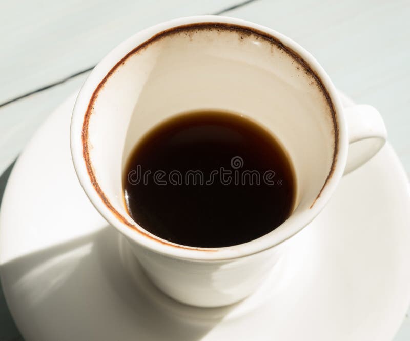 Drunk Cup Of Coffee And Coffee Beans Against White Background Forming
