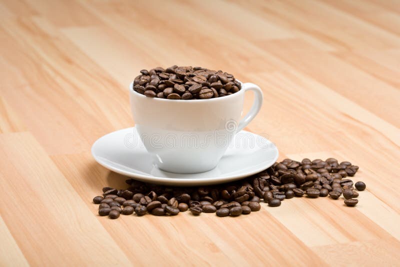 Cup with freshly roasted coffee beans