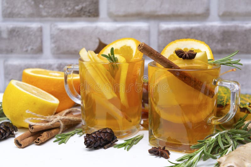 1 Cup of fruit tea with orange and lemon, rosemary, ginger, star anise  on a brick wall background