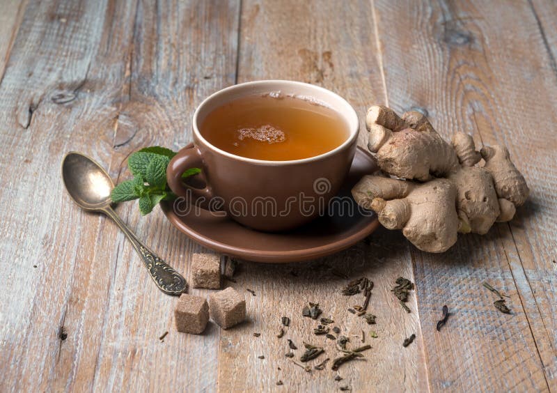 Cup of ginger tea, cubes of brown sugar