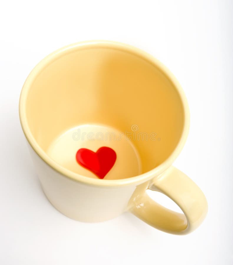 Cup with heart inside stock photography