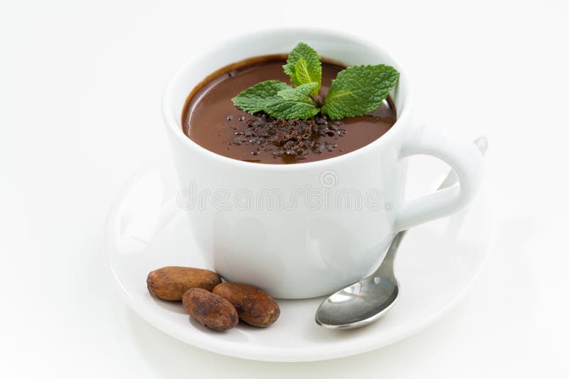 Cup with hot mint chocolate on white table, closeup