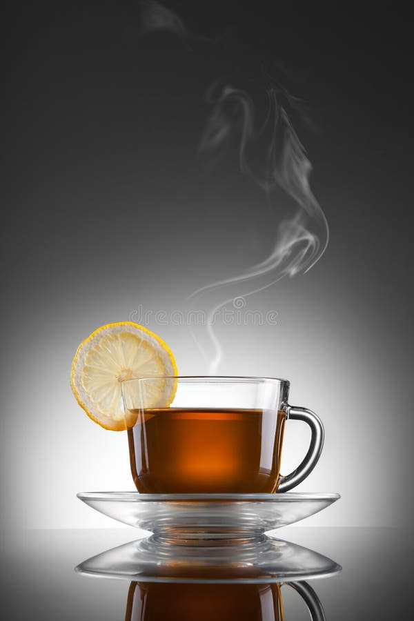 Cup of hot tea with lemon and steam