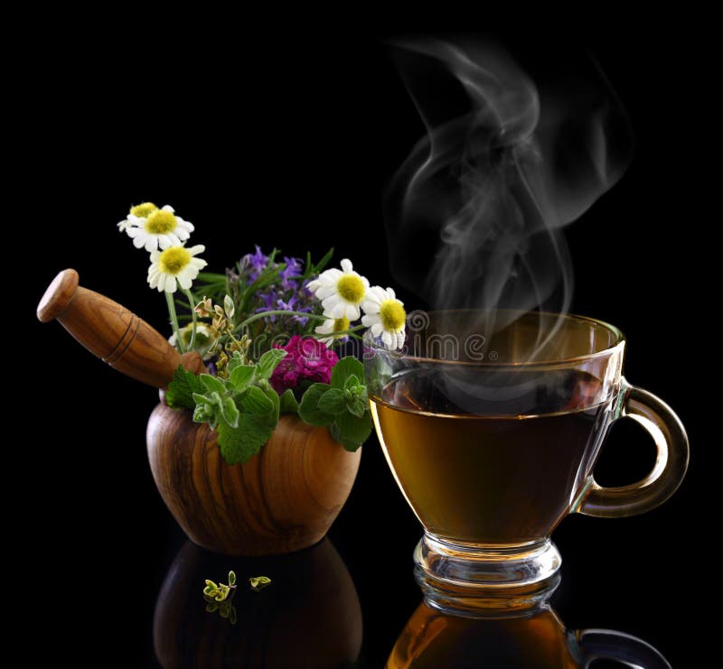 Cup of hot tea and mortar with herbs